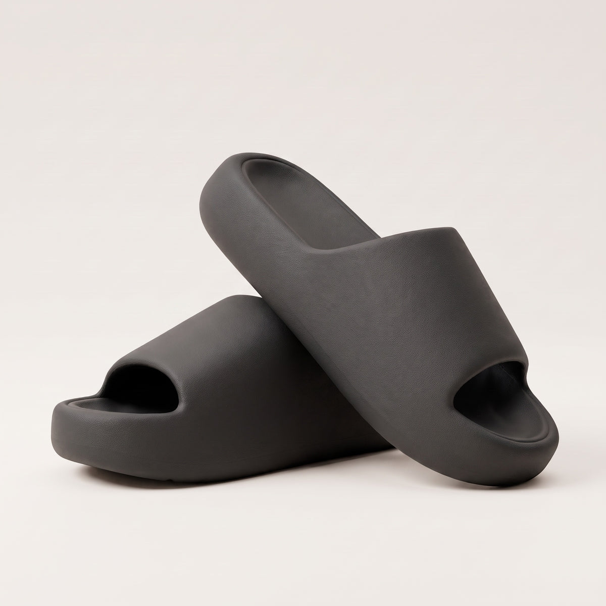 30SNKRS Thick Platform Cloud Slides in black, pair shown on a cream studio background