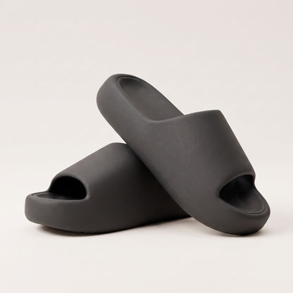 30SNKRS Thick Platform Cloud Slides in black, pair shown on a cream studio background